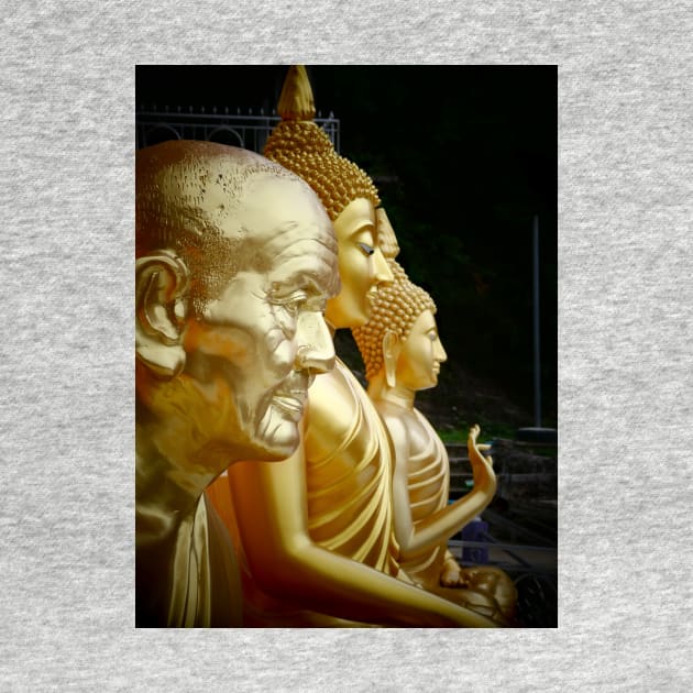 3 Buddhas seated, Thailand. One depicted as an old man. by JonDelorme